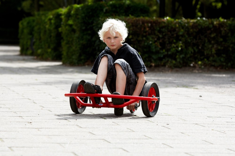 Junge fährt das Winther Viking Swingcart groß auf einem Weg